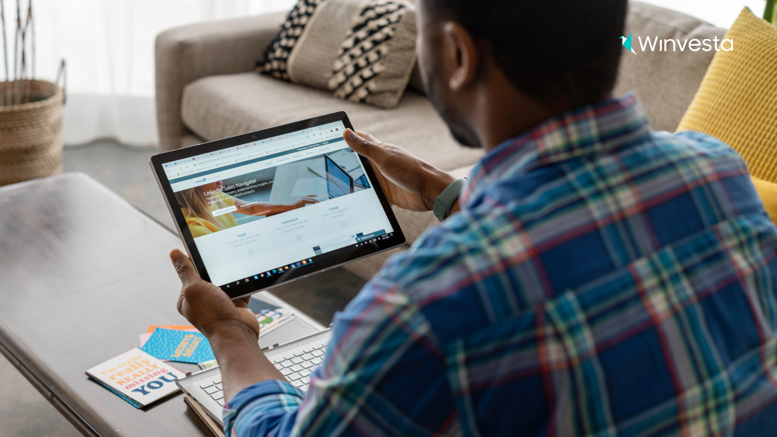 A freelancer using a tablet to explore LinkedIn Sales Navigator, searching for clients and networking opportunities.