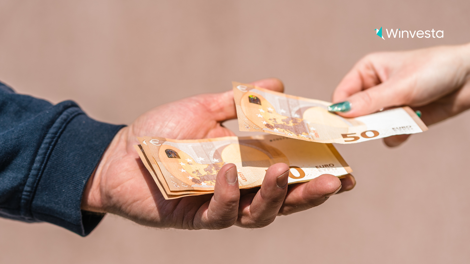 Hands exchanging 50 Euro banknotes, symbolizing the impact of foreign exchange and currency exchange rates on US investment portfolios.